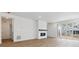 Bright living room with fireplace, wood floors, and sliding glass door to the outside at 9693 Ceylon St, Commerce City, CO 80022