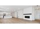 Open-concept living room with a fireplace, bright windows and an adjacent modern kitchen at 9693 Ceylon St, Commerce City, CO 80022