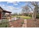 Large backyard featuring a patio, green lawn, and mature trees at 10830 Claire Ln, Northglenn, CO 80234