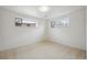 Bright bedroom with neutral carpet and two windows offering natural light at 10830 Claire Ln, Northglenn, CO 80234