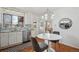 Charming kitchen with white cabinetry, stainless steel appliances, and a cozy breakfast nook area at 10830 Claire Ln, Northglenn, CO 80234