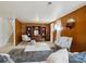 Living room featuring paneled walls, modern furnishings, and a gray accent rug at 10830 Claire Ln, Northglenn, CO 80234
