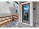 Backyard entryway featuring gray siding, a fenced in path, and a reflective glass door at 28428 E 8Th Pl, Watkins, CO 80137