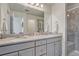 Stylish bathroom features double vanity, granite countertops, and tiled shower with a built-in seat at 28428 E 8Th Pl, Watkins, CO 80137