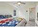 Bedroom featuring a cozy quilt, a ceiling fan, and a large closet at 28428 E 8Th Pl, Watkins, CO 80137