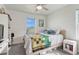 Bedroom featuring a ceiling fan, a bright window and cozy quilt-covered bed at 28428 E 8Th Pl, Watkins, CO 80137