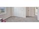 Empty room with neutral carpet, double door closet, and window overlooking the yard at 28428 E 8Th Pl, Watkins, CO 80137