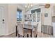 Cozy dining room with a dark wood table, four chairs, and a view through a large window at 28428 E 8Th Pl, Watkins, CO 80137