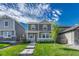Charming two-story home with a well-manicured lawn and inviting walkway to the front door at 28428 E 8Th Pl, Watkins, CO 80137