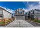 Attractive two-story house with a grey exterior, two-car garage and fenced front yard at 28428 E 8Th Pl, Watkins, CO 80137