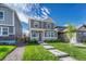Charming two-story home with a well-manicured lawn and inviting walkway to the front door at 28428 E 8Th Pl, Watkins, CO 80137