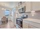 Modern kitchen features stainless steel appliances and gray subway tile backsplash at 28428 E 8Th Pl, Watkins, CO 80137