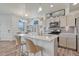Bright kitchen with island, stainless steel appliances, and tile backsplash at 28428 E 8Th Pl, Watkins, CO 80137
