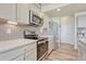 Contemporary kitchen showcasing stainless steel appliances, sleek countertops, and stylish gray cabinetry at 28428 E 8Th Pl, Watkins, CO 80137