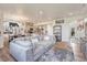 Open-concept living room featuring hardwood floors, recessed lighting, and stylish furnishings at 28428 E 8Th Pl, Watkins, CO 80137