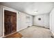 The living room features new carpeting, light gray walls, and a decorative front door at 530 S Quitman St, Denver, CO 80219