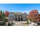 Aerial view of an estate home with a large patio, multiple decks, and stone and stucco siding at 5924 S Kittredge St, Centennial, CO 80016