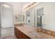 Bathroom featuring dual sinks, custom cabinetry, and lots of counter space at 5924 S Kittredge St, Centennial, CO 80016