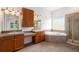 Primary bathroom featuring separate vanities, a soaking tub, and a shower at 5924 S Kittredge St, Centennial, CO 80016