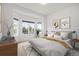 Bright bedroom with bay windows, neutral decor, and a comfortable bed with decorative pillows and a throw at 5924 S Kittredge St, Centennial, CO 80016