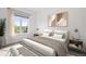 Serene bedroom featuring a plush bed, decorative artwork, and a large window with natural light at 5924 S Kittredge St, Centennial, CO 80016
