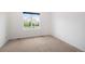 Clean, carpeted bedroom offers a view through a large window with white trim at 5924 S Kittredge St, Centennial, CO 80016