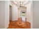 Elegant foyer featuring hardwood floors, custom inlay, arched doorways, and a modern chandelier at 5924 S Kittredge St, Centennial, CO 80016