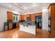 Well lit kitchen featuring wood cabinetry, granite countertops, stainless steel refrigerator and hardwood floors at 5924 S Kittredge St, Centennial, CO 80016
