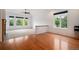 Open-concept living space with hardwood floors, large windows, and a partial wall with decorative molding at 5924 S Kittredge St, Centennial, CO 80016