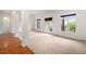 Spacious living room with carpet, natural light, and doors leading to an outdoor deck or patio at 5924 S Kittredge St, Centennial, CO 80016