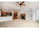 Inviting living room featuring a fireplace, built-in shelving, and an open layout connecting to the kitchen at 5924 S Kittredge St, Centennial, CO 80016