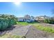 Large backyard with grass and rock gardens, a covered patio, and privacy fencing, perfect for outdoor enjoyment at 1796 S Yampa Way, Aurora, CO 80017