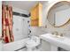 Cozy bathroom with a shower-tub combo, modern sink, and gold hardware at 1796 S Yampa Way, Aurora, CO 80017