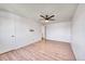 A bedroom with hardwood flooring, a ceiling fan, and an open doorway at 1796 S Yampa Way, Aurora, CO 80017