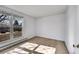 A sunlit bedroom featuring a large window with natural light and wood-look flooring at 1796 S Yampa Way, Aurora, CO 80017