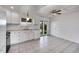 Spacious kitchen featuring white cabinetry, modern appliances, and a door leading to the outdoors at 1796 S Yampa Way, Aurora, CO 80017