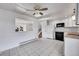 Eat-in kitchen featuring white cabinets, modern appliances, tile floor and backyard access at 1796 S Yampa Way, Aurora, CO 80017