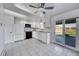 Well-lit kitchen featuring white cabinets, tile flooring, and a sliding glass door to the backyard at 1796 S Yampa Way, Aurora, CO 80017