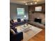 Cozy living room with a brick fireplace, comfortable seating, and warm lighting for a relaxing ambiance at 1796 S Yampa Way, Aurora, CO 80017