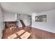 Bright living room featuring hardwood floors, fresh paint, and a cozy brick fireplace at 1796 S Yampa Way, Aurora, CO 80017