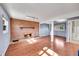 Cozy living room featuring a brick fireplace and wood-look flooring at 1796 S Yampa Way, Aurora, CO 80017