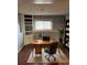 Functional home office with a desk, chair, bookshelves, and natural light for a productive workspace at 1796 S Yampa Way, Aurora, CO 80017