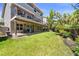 Spacious backyard with a multi-level deck, a lush lawn, mature trees, and a well maintained landscape at 9290 Melborne Ct, Parker, CO 80134