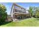 Expansive backyard featuring a multi-level deck, a lush lawn, mature trees, and a beautifully landscaped yard at 9290 Melborne Ct, Parker, CO 80134