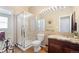 Bathroom with tiled shower, granite countertops, dark wood cabinets and wood-look floors at 9290 Melborne Ct, Parker, CO 80134