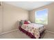 Comfortable bedroom features a bright window with plush carpet and cozy bedding at 9290 Melborne Ct, Parker, CO 80134