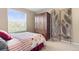 Bright bedroom with a large window, wooden armoire, and decorative screen at 9290 Melborne Ct, Parker, CO 80134