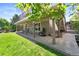 View of the home's covered patio area showing its seamless access to the lush landscaped backyard at 9290 Melborne Ct, Parker, CO 80134
