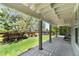 A view of the covered patio with its serene ambiance and a lush, landscaped backyard at 9290 Melborne Ct, Parker, CO 80134