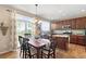 Charming dining area with a wooden table, chairs, chandelier, and large sliding doors at 9290 Melborne Ct, Parker, CO 80134